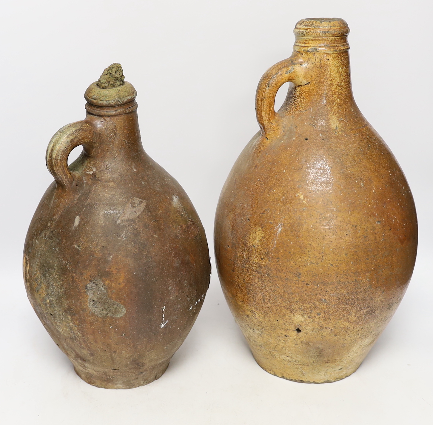 An 18th century German stoneware bellamine and another, 38cm